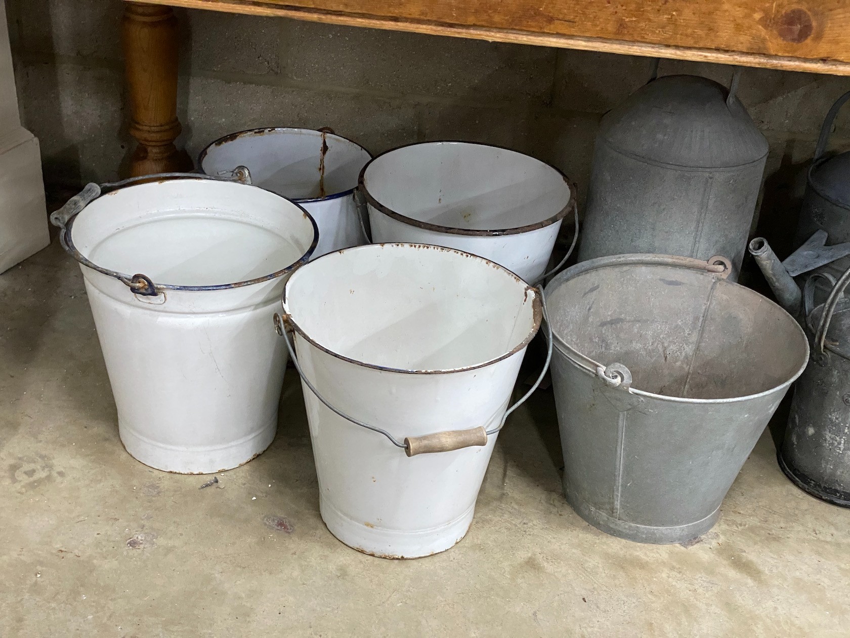 Ten galvanised and enamelled buckets, watering cans and feeder